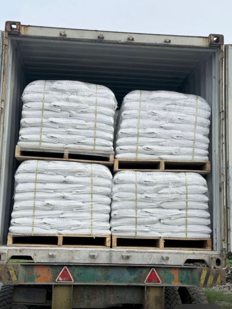 Palletized EFB Ash fertilizer bags loaded in shipping container for export).